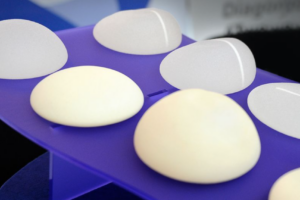 Image of breast implants on purple table showing different types and styles