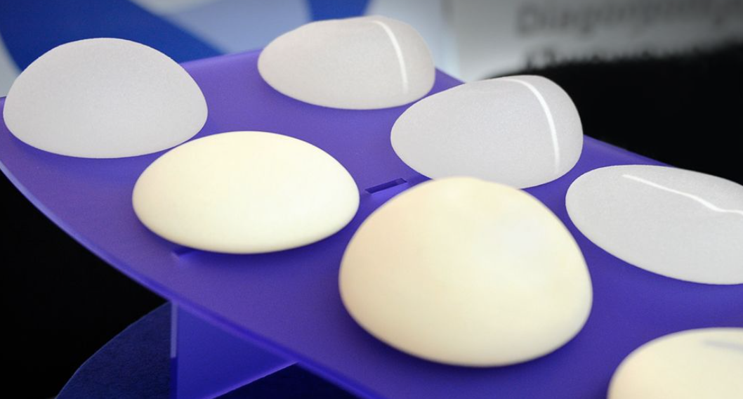 Image of breast implants on purple table showing different types and styles