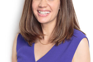 Headshot of Anne Peled, MD in purple top smiling
