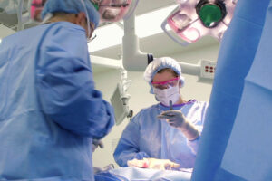 Dr. Anne Peled in the OR Performing Plastic Surgery on a patient with several other physicians