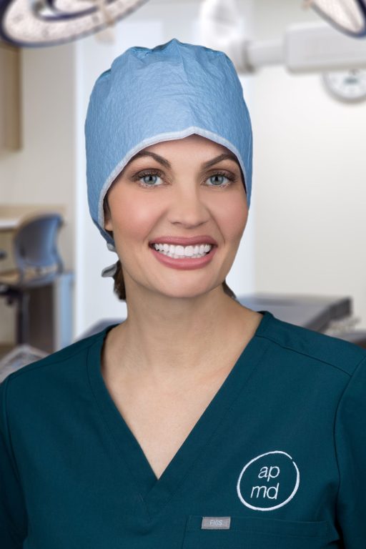 Image of Dr. Anne Peled in a scrub cap and scrubs in an OR setting smiling